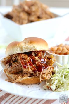 a pulled pork sandwich sitting on top of a blue napkin