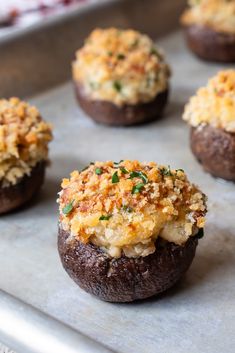 baked mushrooms with cheese and herbs on a baking sheet