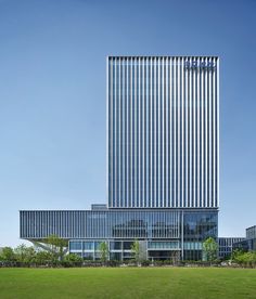 an office building in the middle of a grassy field