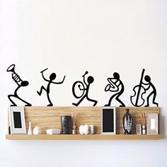 the wall is decorated with black silhouettes of people playing instruments and dancing on it