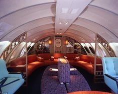 the inside of an airplane with couches and chairs