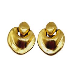 "Vintage 80s Signed Essex Heavy Matte Gold Abstract Earrings (A1276) Size: 2.25\" Color: Matte gold Condition: Good vintage; some scratches to finish Era: Circa 1980s Signed: Essex Details: Very heavy! Please look at all the photos, as they are part of the description. I try my best to point out any flaws. Also please remember this is a preloved piece and may show signs of light wear, marks, scratches, etc. I will be posting a lot more jewelry, Keep checking back." Retro Gold Metal Earrings, Gold Retro Metal Earrings, Retro Gold Earrings For Parties, Gold Retro Earrings For Party, Retro Gold Clip-on Earrings For Party, Gold Retro Clip-on Earrings For Party, Retro Gold Evening Earrings, Retro Gold Earrings For Evening, Retro Gold Drop Clip-on Earrings