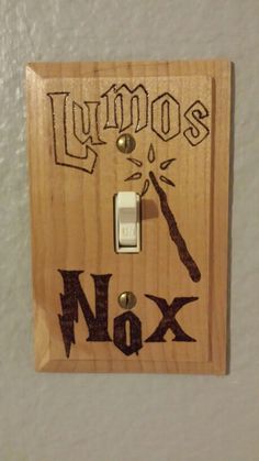 a light switch cover with the word lumos next to scissors and an x on it