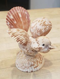 a seashell shaped figurine sitting on top of a wooden table