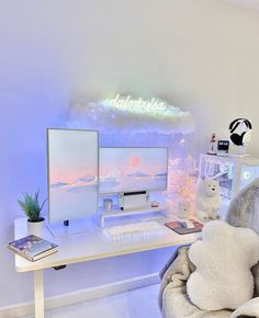 a white desk with two computer monitors and a stuffed animal on it's lap