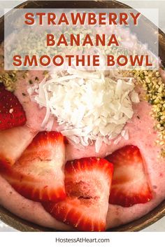 strawberry banana smoothie bowl with coconut sprinkles and strawberries in it