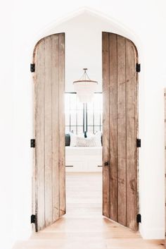 an open wooden door leading to a bedroom