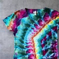 **THIS SHIRT RUNS SMALL**   Chest (underarms): 44" Length:  27 1/2" An abstract rainbow pattern in multi colors.    This is a Next Level 3940 Relaxed TShirt with tear off labels.   4.3 oz.,100% combed ring-spun cotton fine jersey, side seams This is a lightweight shirt, and less boxy, more fitted than some.  Also, it has been preshrunk - so be sure to check these measurements before ordering: Chest (underarms): 44" Length:  27 1/2" Recommend cold wash & tumble or hang dry with like colors. Messa Multicolor Bohemian Relaxed Fit T-shirt, Bohemian Multicolor Relaxed Fit T-shirt, Bohemian Style Multicolor Relaxed Fit T-shirt, Multicolor Rainbow Print Tops For Festivals, Festival Multicolor Tops With Rainbow Print, Festival Multicolor Rainbow Print Tops, Hand Dyed Rainbow Top For Summer, Bohemian Multicolor Hand-dyed Tops, Rainbow Hand Dyed Short Sleeve Tops