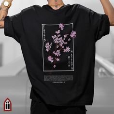 Introducing our "Clothed with Majesty" graphic tee, inspired by Psalm 104 and Japanese Streetwear. This Christian streetwear t-shirt features a striking vertical inscription on the front, with the word "Honor" and a graphic of a delicate pink Japanese Cherry Blossom branch.  On the back of the shirt, you'll find the powerful scripture from Psalm 104:1-9, "Bless Yahweh, my soul. Yahweh, my God, you are very great. You are clothed with honor and majesty." The scripture is accompanied by a stunning image of a large pink Japanese Cherry Blossom branch, adding a unique and meaningful touch to the tee. Available in 14 colors and 7 sizes, our graphic tee is perfect for both men and women. It serves as a beautiful expression of faith and a reminder of the majesty of our Creator. Whether you're loo Cherry Blossom T Shirt, Japanese Cherry Blossom Branch, Cherry Blossom Shirt, Gift For Pastor, Psalm 104, Bible Verse Tees, Anime Shirts, Christian Streetwear, Blossom Branch