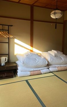 there are many pillows on the bed in this room