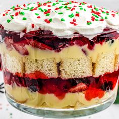 a trifle cake with white frosting and berries