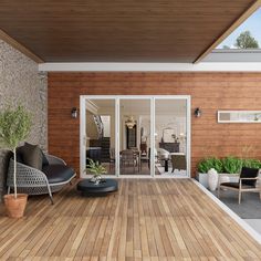 an outdoor living room with wood flooring and wooden walls, surrounded by potted plants