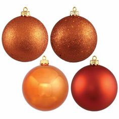 three red and one orange christmas ornaments on a white background