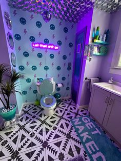 a bathroom decorated in purple and blue with an interesting pattern on the floor, walls and ceiling