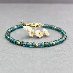 "✦This stunning Czech glass seed bead bracelet is just the thing you need to wear with your spring and summer wardrobe. It is the perfect versatile bracelet to add a touch of artistic flair to your life.  ✦Faceted turquoise green-blue Czech glass seed beads are accented with delicate gold seed beads to create a unique and eye-catching design.  ✦With its stretch stacking style, the bracelets are comfortable and easy to wear. Whether worn alone or layered with other bracelets, they are a must-have Spiritual Turquoise Beaded Bracelets With Tiny Beads, Spiritual Turquoise Beaded Bracelet With Tiny Beads, Spiritual Turquoise Beaded Bracelet, Hand-strung Turquoise Beaded Bracelets With Czech Glass, Adjustable Turquoise Stretch Bracelet With Tiny Beads, Turquoise Beaded Bracelets With Gold Beads, Turquoise Beaded Bracelets With Gold Accents, Turquoise Czech Glass Beaded Bracelets, Turquoise Czech Glass Beaded Bracelet With Faceted Beads