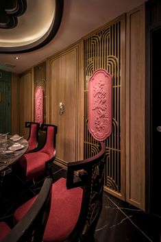 a fancy dining room with red chairs