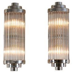 two chrome and glass wall lights on a white background