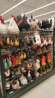 there are many chickens and rooster figurines on the shelves in this store,