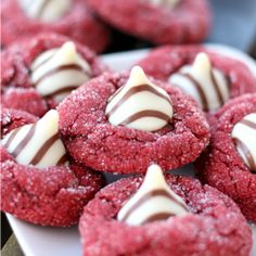 red velvet cookies with white chocolate and drizzled in the middle on a plate