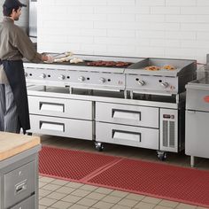 a man standing in front of an oven with food on it's grill top