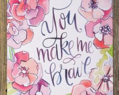 a sign that says you make me beautiful with flowers and butterflies in the background on a wooden frame