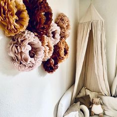 there is a baby crib with flowers hanging on the wall