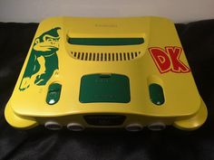 a yellow and green electronic device sitting on top of a bed