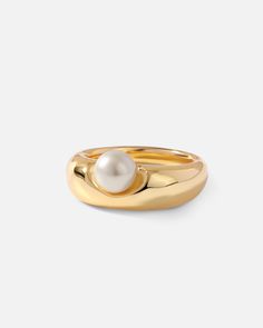 Add a subversive-basic design of modern artistry to your stacked ring collection with this dented pearl dome ring. A shiny pearl atop a flat chunky band gives this statement ring an innovative yet minimalist appearance perfect for any occasion.

Band Width: 8mm
Band Thickness: 2.8mm
Material: Pearl,18k Gold Plated On Brass Modern Pearl Ring, Minimalist Pearl Ring, Basic Ring, Gold Ring With Pearl, Classic Gold Pearl Ring, Gold Pearl Ring With Metal Band, Golden Pearl Ring, Dome Ring, Gold Plated Pearl Ring