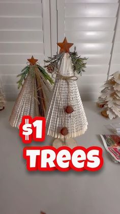 three christmas trees made out of book pages with text overlay that reads $ 1 tree