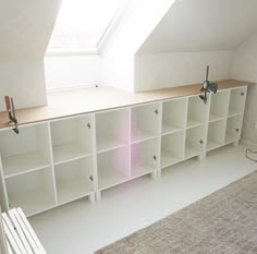 a room with some shelves and a window