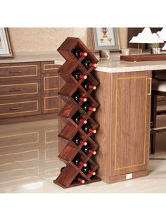 a wooden wine rack in the middle of a kitchen floor with marble countertops and cabinets