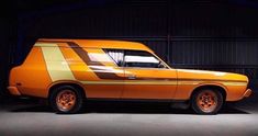 an orange and yellow car parked in a garage