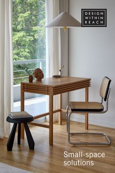 a small wooden table sitting in front of a window next to a chair and lamp