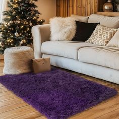 a living room filled with furniture and a christmas tree