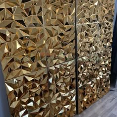 two gold mirrors are on the wall next to each other, one is made out of metal