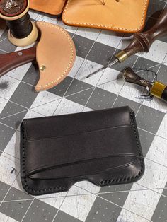 "This genuine leather card holder will hold around 15 business cards or eight credit cards or IDs. It has a flap closure, no hardware, and has a thumb slot at the bottom which allows cards to be pushed up for easy access. The holder has been hand stitched with black threaded polyester thread. Features -------- External Pouch Dimensions (H x D x W): 3\" x .5\" x 4.5\" Weight: around 2 oz The leather used is 5oz (5/64\") Wickett & Craig Black English Bridle Leather, this leather has a beautiful ba Sewing Machine Stitches, Leather Business Card Holder, Sewing Leather, Business Card Holders, Id Holder, Card Holder Leather, Purse Pouch, Leather Items, Leather Tooling