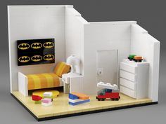 a lego model of a bedroom with batman decorations on the wall and bed in the corner