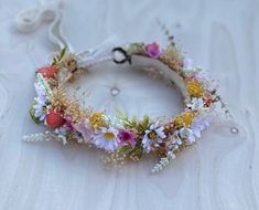 On this bohemian wildflower crown, preserved baby's breath and greenery twirl around a twisted bark-covered vine. Adorned with various daisies, wild flowers and yarrow. White and yellow with accents in burnt orange and pink.  It's a perfect wildflower feel for your spring and summer festivities! Two small loops in back will tie with ivory crochet lace ribbon or jute twine. Comes in 4 sizes:  -Newborn (NB-6M) -Baby fits 6M-2 years. A gorgeous baby photo prop! -Child fits girls ages 2-12. So pretty on little flower girls. -Adult fits 13+ Ideal for bridal crowns, engagement photos. This crown is a combination of preserved and faux elements. Wildflower Flower Crown, Wild Flower Crown, Crochet Lace Ribbon, Yellow Flower Crown, Wildflower Crown, Flower Crown Hairstyle, Flower Girl Crown, Girls Crown, Bridal Flower Crown