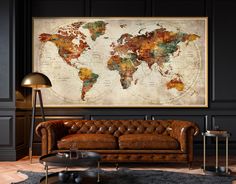 a living room filled with furniture and a large map on the wall above it's couch