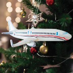 an airplane ornament hanging from a christmas tree