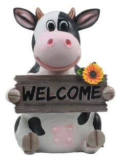 a cow holding a welcome sign with a flower in it's mouth and smiling