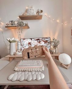 a person is sitting at a desk with a computer and keyboard in front of them