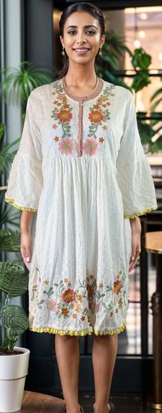 Embrace effortless elegance with our Adorable Floral Embroidered Cotton Dress, a perfect blend of traditional Indian craftsmanship and modern boho style. Made from soft, breathable cotton, this dress is designed for comfort and style. The intricate floral embroidery adds a touch of delicate artistry, making it a standout piece in any wardrobe. The dress features charming bell sleeves that enhance its bohemian appeal, adding a playful and romantic vibe. Whether you're attending a casual day out, a garden party, or a relaxed evening event, this dress is versatile enough to suit any occasion. Folk Cotton Dress With Resham Embroidery, Festive Summer Kurta With Embroidered Hem, Bohemian Embroidered Dress For Brunch, Bohemian V-neck Embroidered Dress For Festive Occasions, Folk-style Cotton Dress With Resham Embroidery, Folk Style Cotton Embroidered Dress With Resham Embroidery, Bohemian Chikankari Embroidered Festive Dress, Bohemian Chikankari Embroidery Festive Dress, Festive Bohemian Dress With Embroidered Sleeves