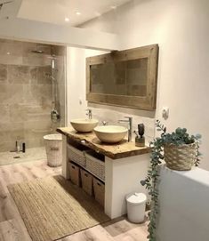 a bathroom with two sinks and a large mirror on the wall next to a bathtub