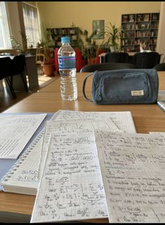 a table with papers and a water bottle on it