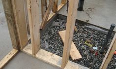 an unfinished room with wood framing and construction tools on the ground next to it,