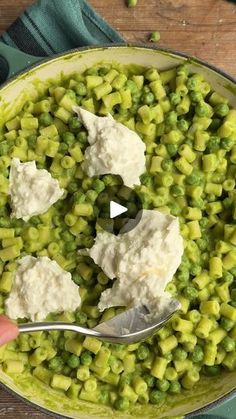 a bowl filled with peas and feta cheese