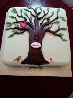 the cake is decorated with a tree and hearts