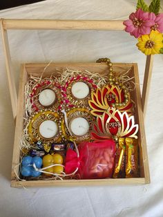 a wooden box filled with assorted candies and candles