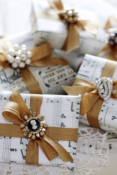 some wrapped presents are sitting on top of sheet music